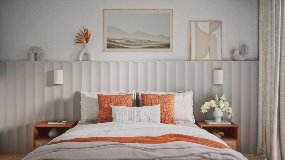 Bedroom with a panelled headboard wall, orange cushions and matching bedside tables