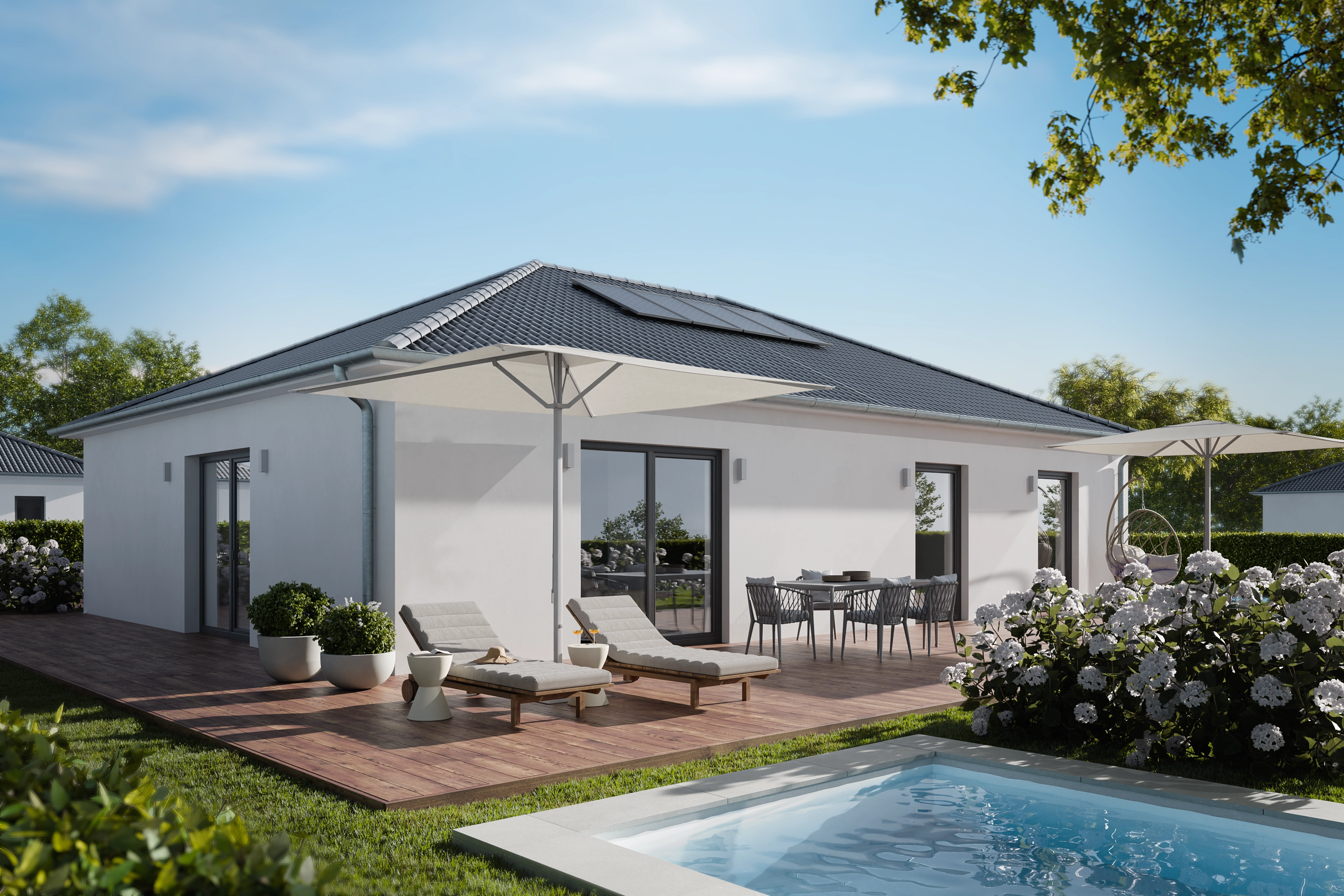 Single-storey white house with a terrace, sun loungers and a pool in daylight