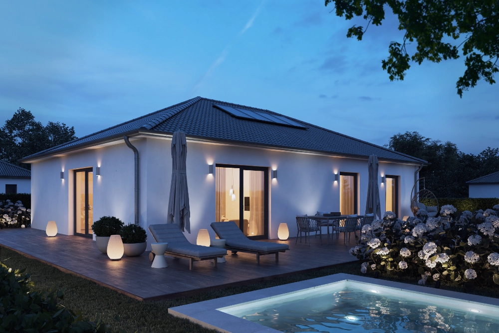 The same single-storey house and pool at dusk with the outdoor lights on