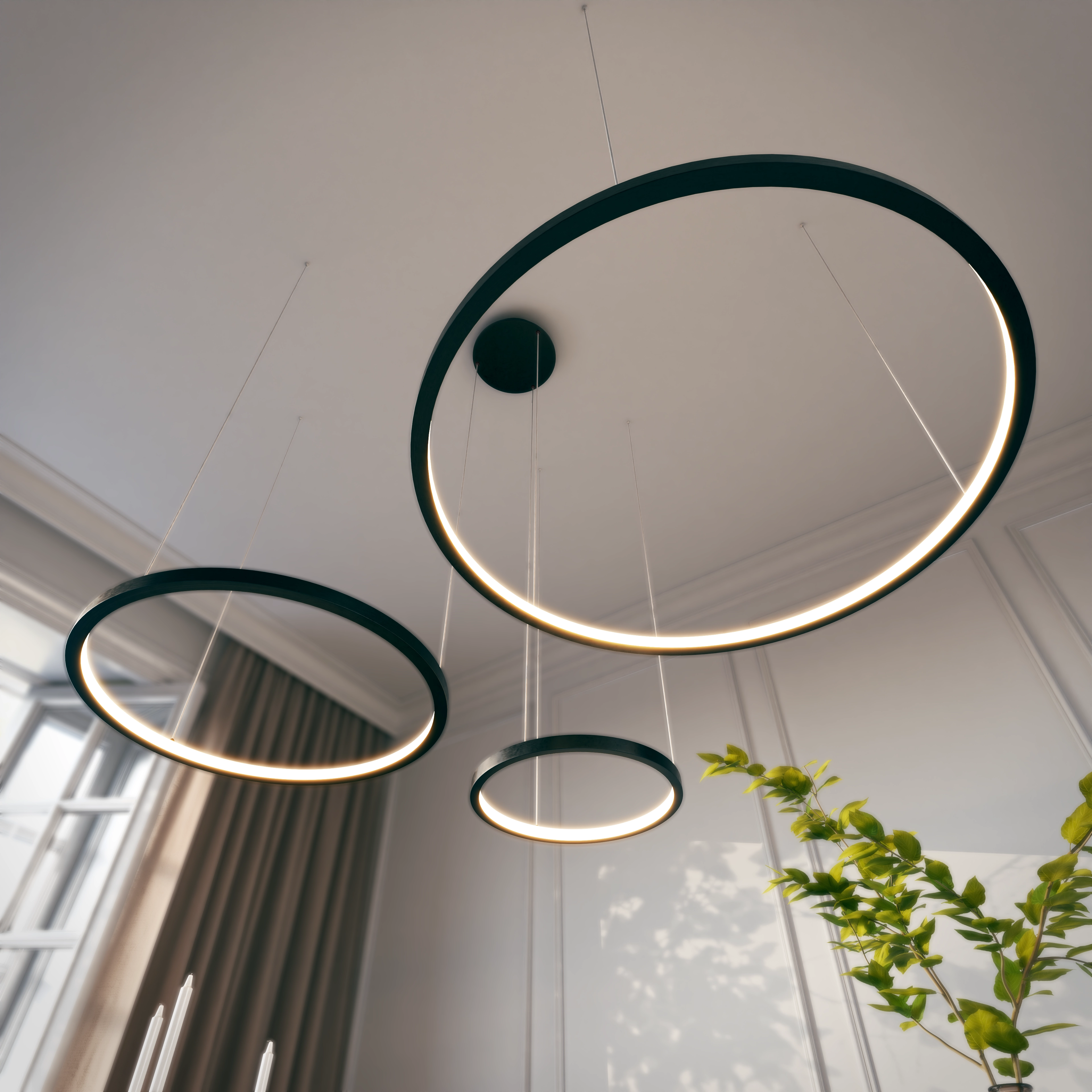 Three black ring LED pendant lights seen from below